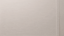 a stuffed monkey is looking at the camera with a white background
