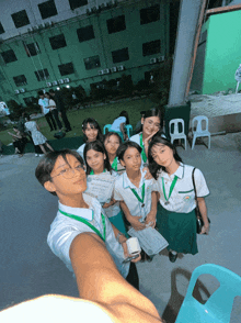 a group of young girls are posing for a picture in front of a building with a green roof