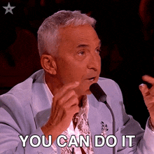 a man speaking into a microphone with the words " you can do it " below him