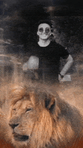 a man standing next to a lion in a black and white photo