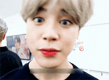 a close up of a person 's face with red lipstick