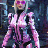 a woman in a pink suit and sunglasses says space out on the bottom