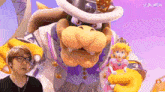 a man wearing glasses is standing next to a cartoon character .