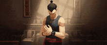 a man in a black tank top is standing in a room with chinese writing on the wall
