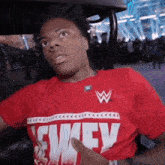 a man wearing a red shirt with the word wwe on it