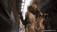 a woman wearing a fur coat and a hat is walking down a city street .