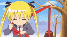 a girl with blonde hair and a red tie is standing in front of a tree .