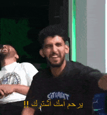 a man wearing a shirt that says ' stealth ' on it is laughing