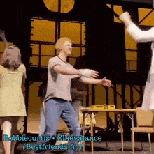 a group of people are dancing on a stage with the words robbie curtis + ellievalance bestfriends in the corner .