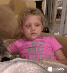 a little girl wearing a pink let me sleep shirt