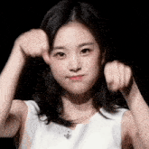 a young woman in a white tank top is making a face