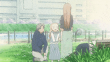 a man kneeling down next to a woman and a little girl with the letter m on their shirt