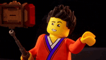 a lego man is holding a hammer in his hand