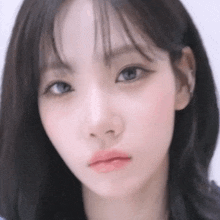 a close up of a woman 's face with a serious look on her face