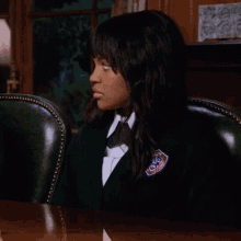 a girl in a school uniform has a badge on her jacket that says ' washington ' on it