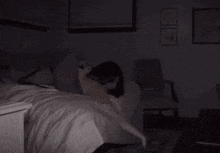 a person is laying on a bed in a dark room