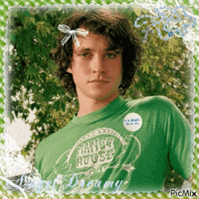 a young man wearing a green shirt that says fancy house