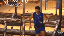 a man wearing a blue shirt that says dam on it