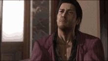 a man in a red striped suit is sitting on a couch in a room .