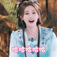 a woman wearing a blue dress with chinese writing on it
