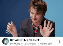 a man is holding a pair of scissors and breaking my silence