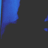a person in a dark room with a blue light