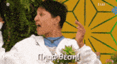 a woman in a white hoodie is making a funny face with a foreign language on the bottom