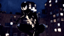 a man in a black spiderman costume is standing in the rain