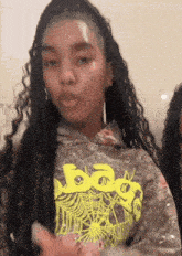 a woman wearing a hoodie that says baggy on it