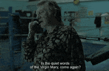 a man talking on a phone with the words " in the quiet words of the virgin mary come again "