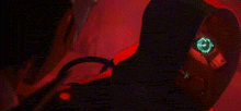 a close up of a person 's face with glowing eyes in a red light .