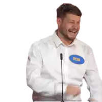a man in a white shirt laughs while holding a blue object