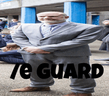 a man in a suit and tie is standing in front of a group of people with the words " te guard " on the bottom
