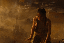 a person is standing in a dark room in a foggy room .
