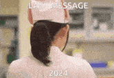 a woman in a nurse 's uniform has the words last message 2024 written on her back
