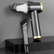 a black vacuum cleaner with a small brush attached to it