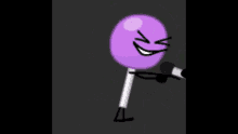 a purple lollipop with an angry face on it is being held by someone .