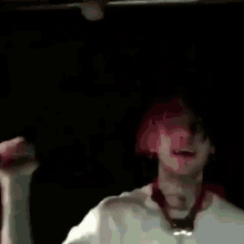 a close up of a person singing into a microphone in a dark room .