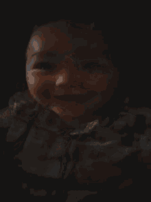 a baby is laying on a bed with his eyes closed and his mouth open .