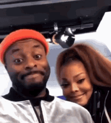a man and a woman are posing for a picture on a plane