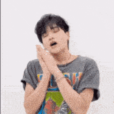 a man wearing a t-shirt with the word rush on it is yawning