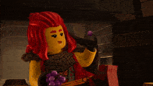 a lego figure with red hair and a shirt that says ' ninjago ' on it