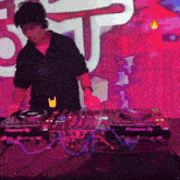 a man wearing headphones is playing a pioneer dj