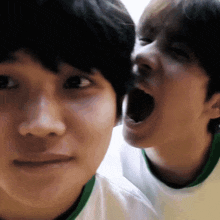a close up of two people 's faces with one making a funny face