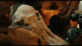 a close up of a monster with a gas mask on