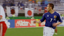 a soccer player with the number 7 on his jersey is running on the field