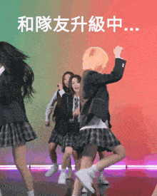 a group of girls in school uniforms are dancing on a stage