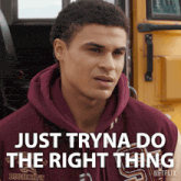 a man wearing a maroon hoodie with the words just tryna do the right thing