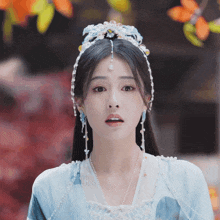 a woman wearing a blue and white dress and a headband