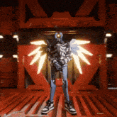 a robot with wings is standing in front of a red building